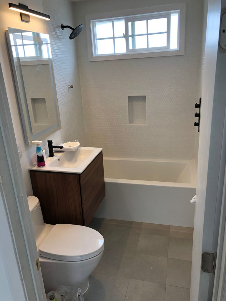 Guest bathroom renovation with elegant fixtures and tile work