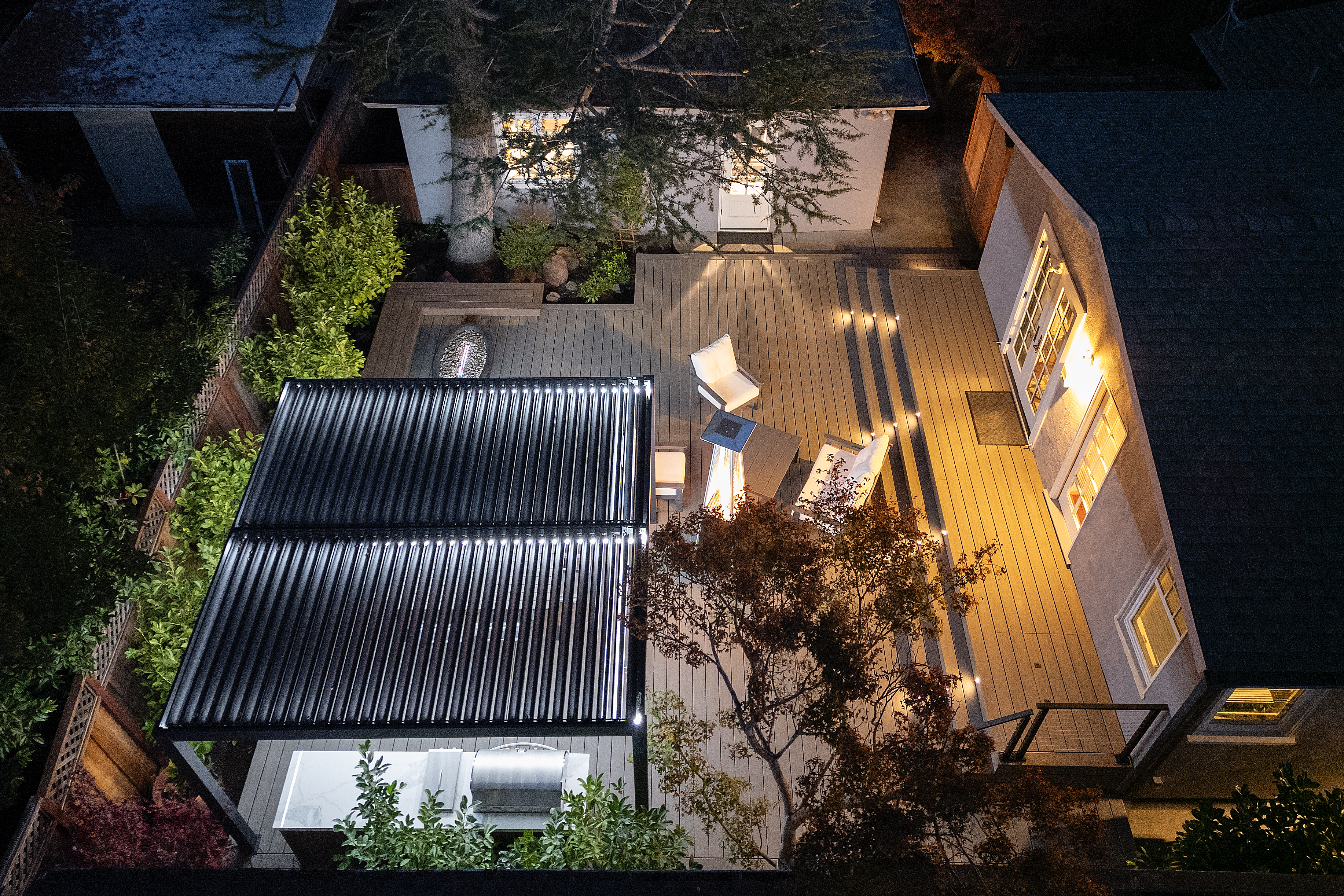 Before and after backyard transformation with new deck and landscaping